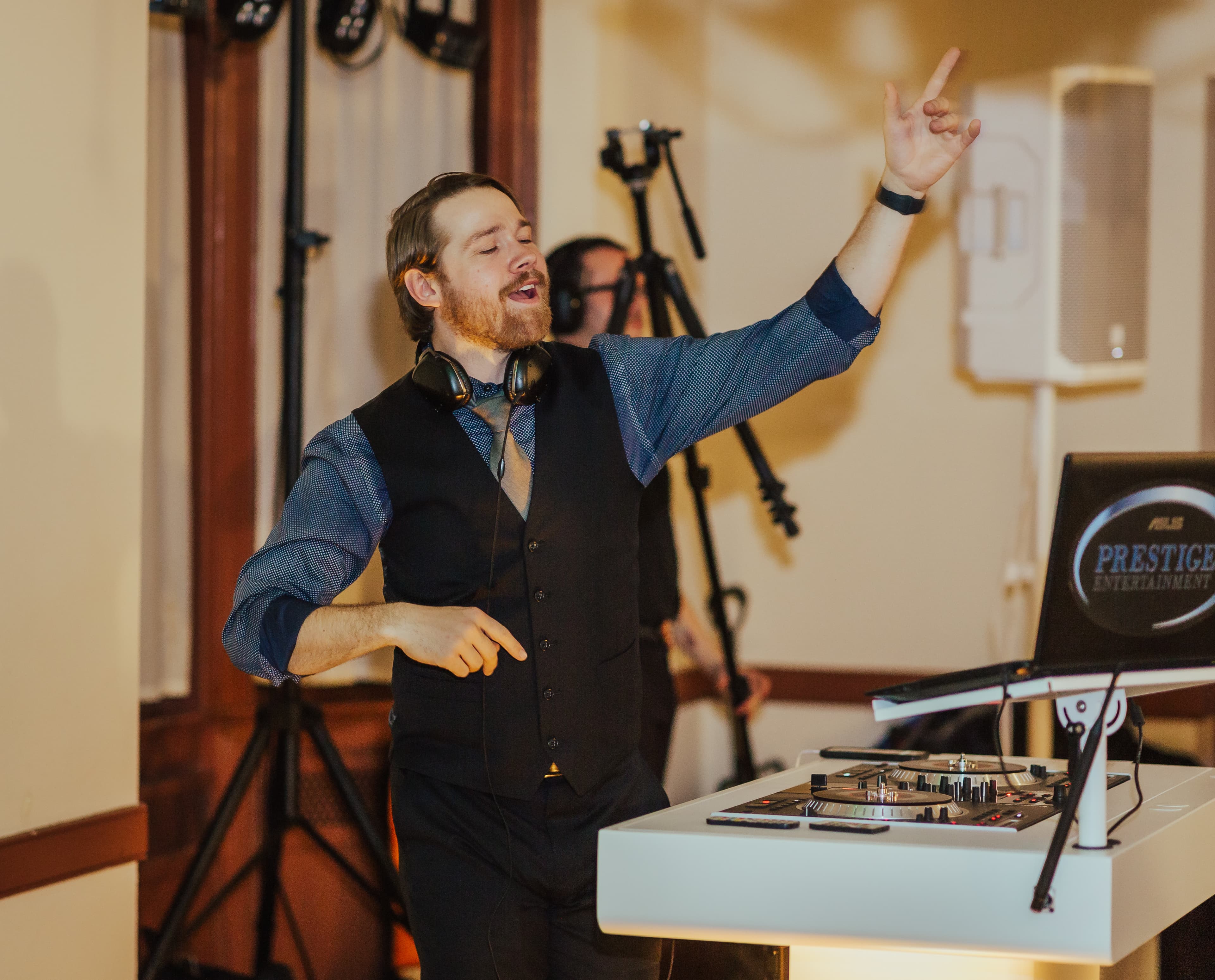 Noah DeVoe MCing a wedding reception, mid-hype-moment with the crowd